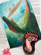 Picture of the print, sticker, and letter that comes with the April edition of The Paleo Post. A Spinosaurus Mirabilis and a Lurdusaurus are both featured. 