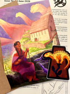 An illustrated art print featuring a woman reading a khipu in a landscape with sauropods in the background, and a small dinosaur-shaped sticker in the foreground.